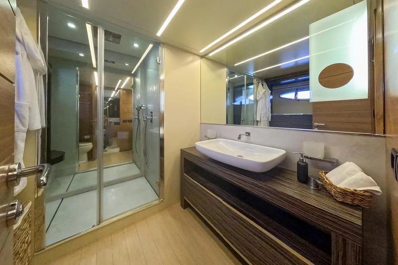 Honey Badger Yacht Photos Pics Luxurious bathroom interior on a 2012 Pershing 92 yacht, featuring modern fixtures and elegant design.