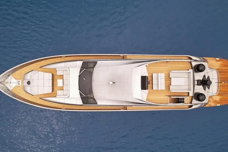 Honey Badger Yacht Photos Pics Aerial view of 2012 Pershing 92 yacht on blue water.
