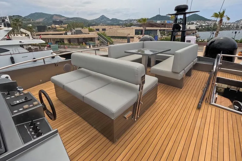 Honey Badger Yacht Photos Pics Luxurious 2012 Pershing 92 yacht deck with modern seating and scenic marina view.