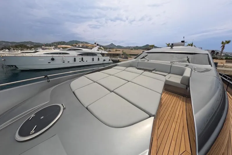 Honey Badger Yacht Photos Pics 2012 Pershing 92 yacht with sleek design and spacious deck in marina setting.