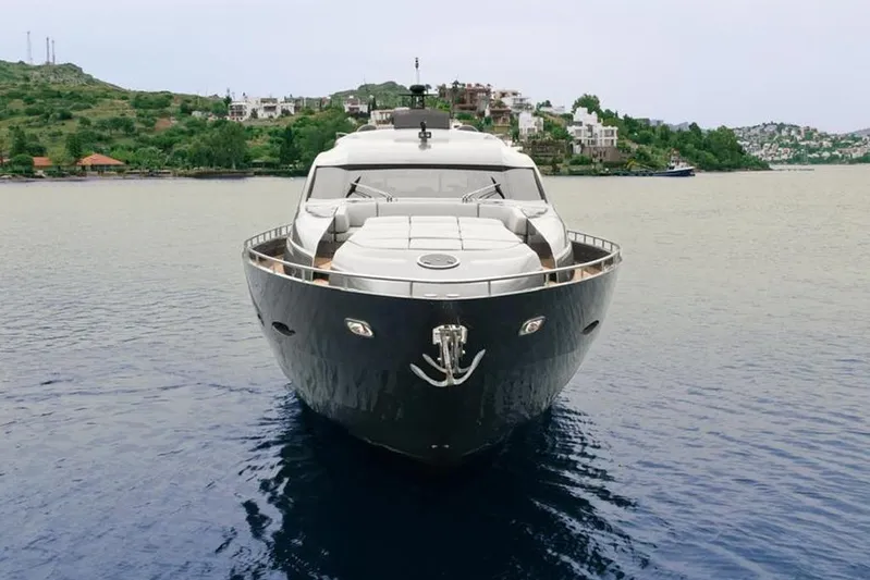 Honey Badger Yacht Photos Pics Front view of a 2012 Pershing 92 yacht on calm waters.