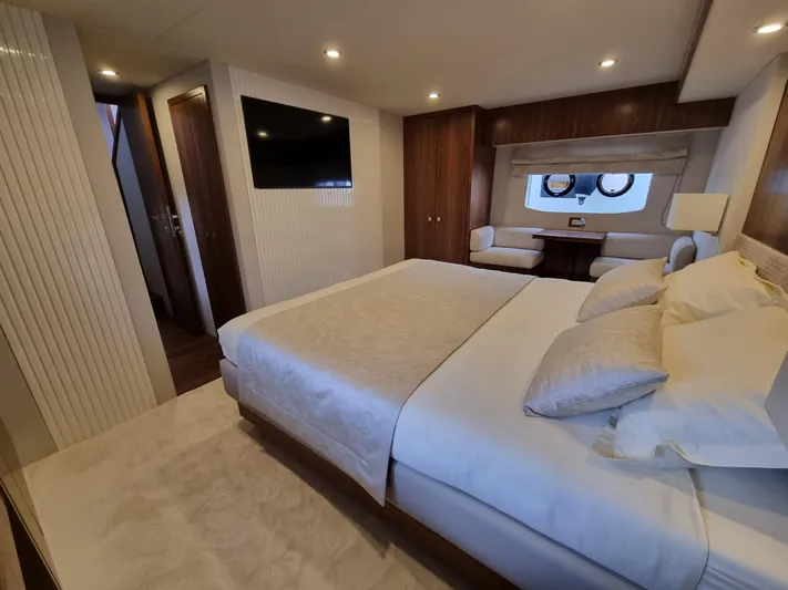 Panta Rei Yacht Photos Pics Luxurious bedroom interior of 2022 Monachus 70 Fly yacht with modern decor and cozy bedding.