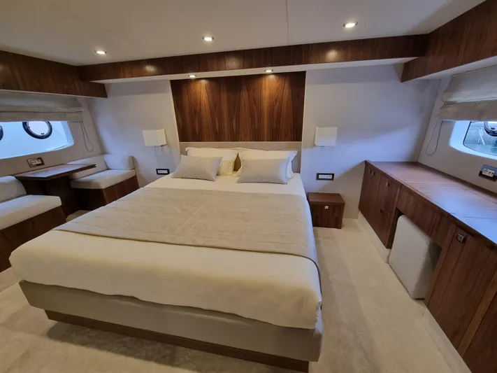 Panta Rei Yacht Photos Pics Luxurious bedroom interior of 2022 Monachus 70 Fly yacht with modern wood accents.