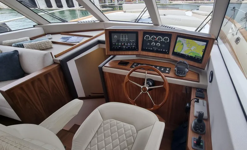 Panta Rei Yacht Photos Pics Luxurious Monachus 70 Fly 2022 yacht cockpit with modern navigation systems and elegant wood finish.