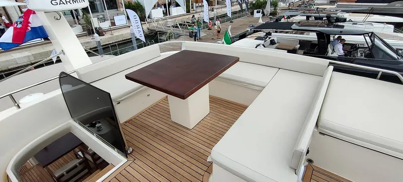 Panta Rei Yacht Photos Pics Luxurious 2022 Monachus 70 Fly yacht deck with seating and wooden table.