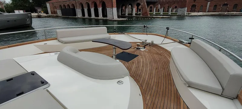 Panta Rei Yacht Photos Pics Luxurious 2022 Monachus 70 Fly yacht deck with elegant seating and scenic waterfront view.