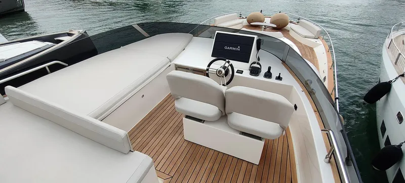 Panta Rei Yacht Photos Pics Luxurious 2022 Monachus 70 Fly yacht interior with sleek helm and spacious seating.