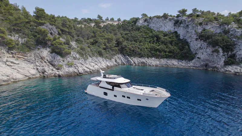 Panta Rei Yacht Photos Pics Luxury Monachus 70 Fly yacht in serene coastal waters, 2022 model.