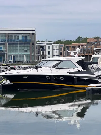 Rough Play Yacht Photos Pics 2010 Regal 600 Express yacht docked in a modern marina setting.