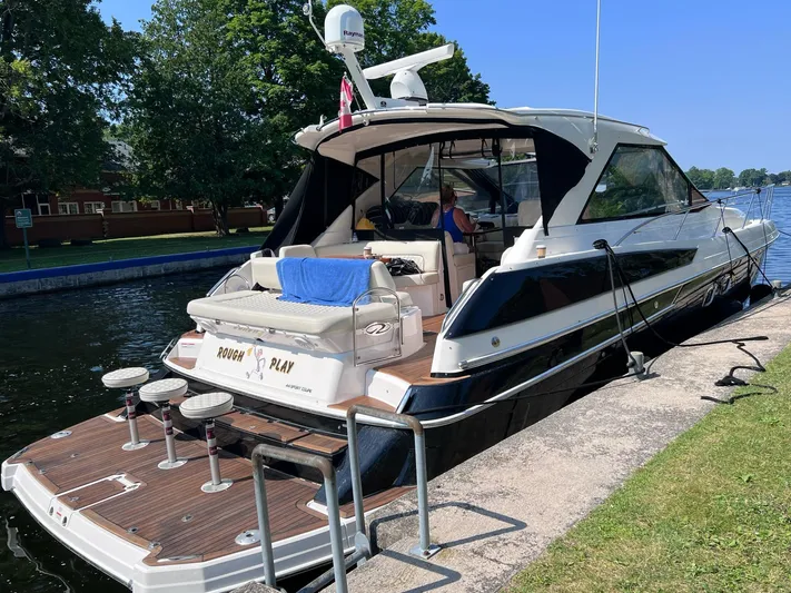 Rough Play Yacht Photos Pics 2010 Regal 600 Express yacht docked by a canal, featuring a spacious deck and modern design.