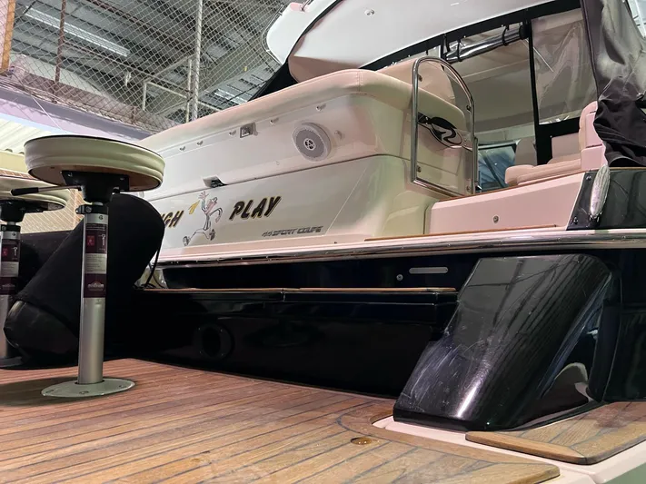 Rough Play Yacht Photos Pics 2010 Regal 600 Express yacht with wooden deck and seating area in a marina.