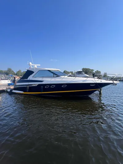 Rough Play Yacht Photos Pics 2010 Regal 600 Express boat docked on calm water under clear blue sky.