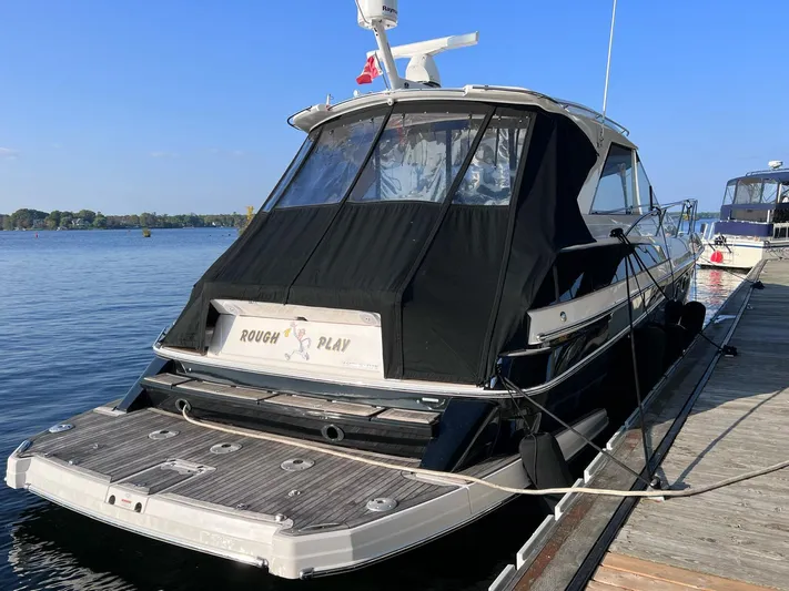 Rough Play Yacht Photos Pics 2010 Regal 600 Express yacht docked, rear view with black cover, sunny day.
