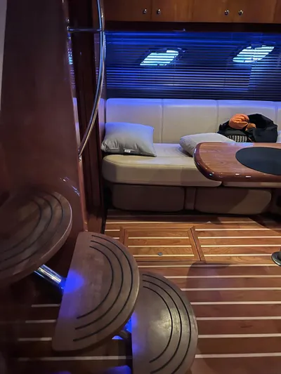 Rough Play Yacht Photos Pics Interior of 2010 Regal 600 Express yacht with wooden steps and cozy seating area.