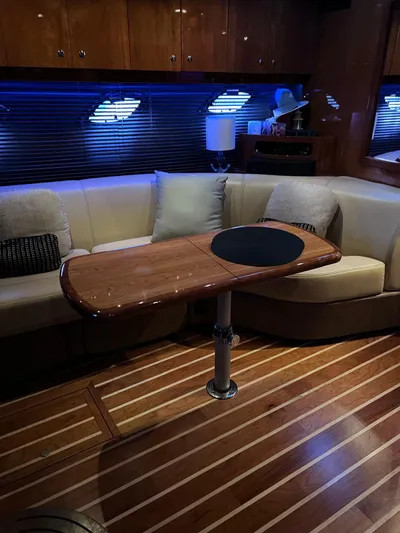 Rough Play Yacht Photos Pics Luxurious interior of 2010 Regal 600 Express yacht with wooden table and plush seating.