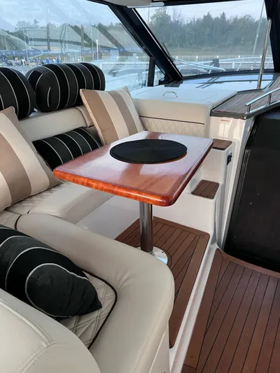 Rough Play Yacht Photos Pics Luxurious interior of 2010 Regal 600 Express yacht with elegant seating and wooden table.