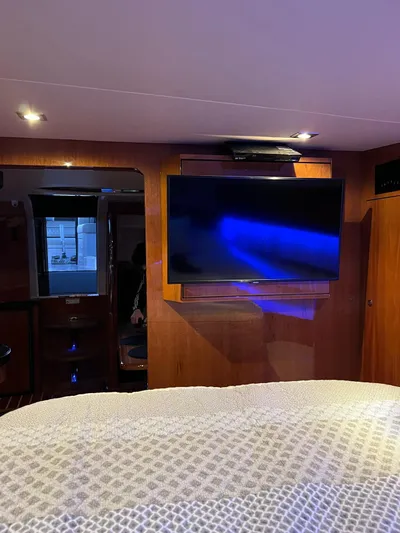 Rough Play Yacht Photos Pics Interior of 2010 Regal 600 Express yacht with TV and cozy lighting.
