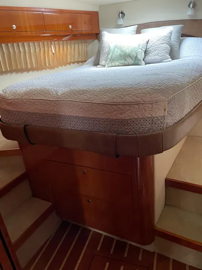 Rough Play Yacht Photos Pics Luxurious cabin interior of 2010 Regal 600 Express yacht with cozy bed and wooden accents.