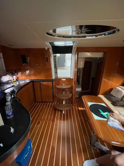 Rough Play Yacht Photos Pics Interior of 2010 Regal 600 Express yacht with wooden flooring and modern amenities.