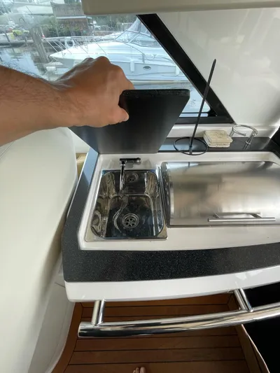 Rough Play Yacht Photos Pics 2010 Regal 600 Express yacht kitchenette with sink and stove.