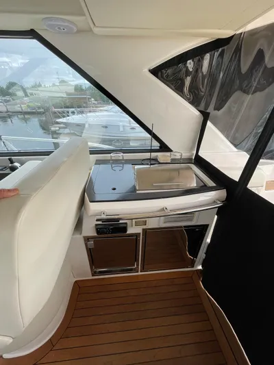 Rough Play Yacht Photos Pics 2010 Regal 600 Express yacht interior with sleek kitchenette and wooden flooring.