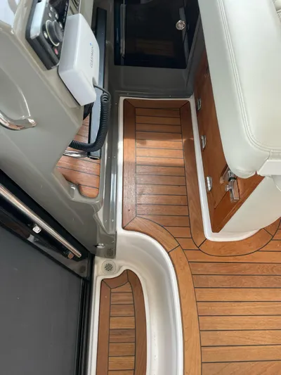 Rough Play Yacht Photos Pics Interior view of 2010 Regal 600 Express boat with wood flooring and seating.