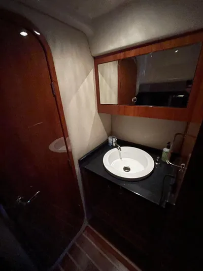 Rough Play Yacht Photos Pics 2010 Regal 600 Express yacht bathroom with wooden cabinetry and modern sink.
