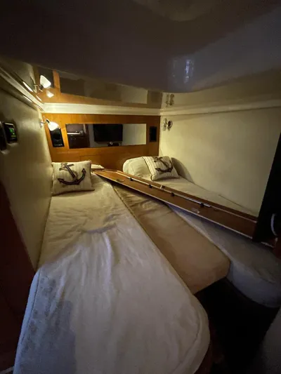 Rough Play Yacht Photos Pics Interior cabin of 2010 Regal 600 Express with twin beds and cozy lighting.