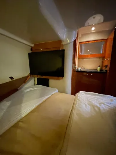 Rough Play Yacht Photos Pics 2010 Regal 600 Express cabin interior with bed, TV, and kitchenette.