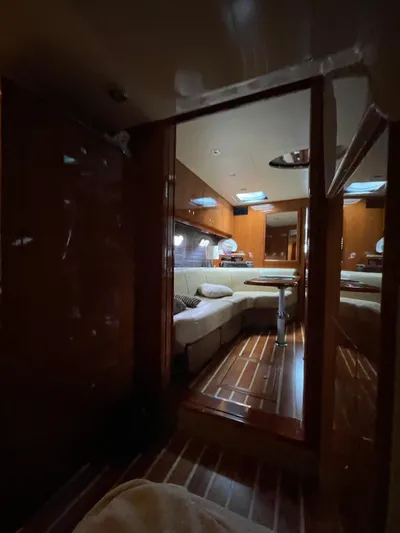 Rough Play Yacht Photos Pics Interior of 2010 Regal 600 Express yacht with wooden flooring and cozy seating area.