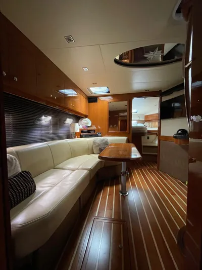 Rough Play Yacht Photos Pics Luxurious interior of 2010 Regal 600 Express yacht with elegant wood finishes and plush seating.