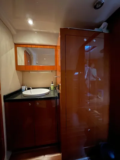 Rough Play Yacht Photos Pics Luxurious 2010 Regal 600 Express yacht bathroom with wooden cabinetry and modern sink.