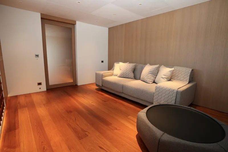  Yacht Photos Pics Luxurious interior of 2024 Rossinavi 49M Sport Yacht with modern sofa and wooden flooring.