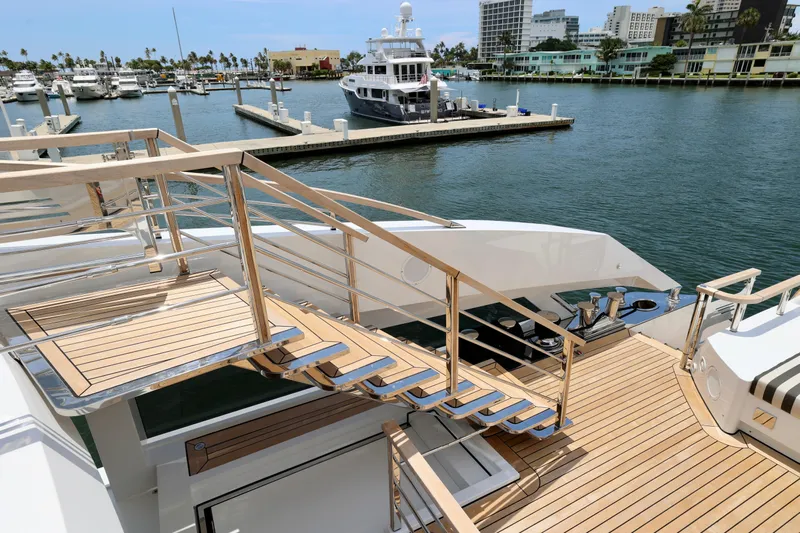  Yacht Photos Pics Luxurious 2024 Rossinavi 49M Sport Yacht docked at marina, featuring elegant wooden deck.