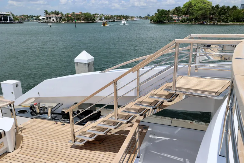  Yacht Photos Pics 2024 Rossinavi 49M Sport Yacht deck with sleek stairs and waterfront view.