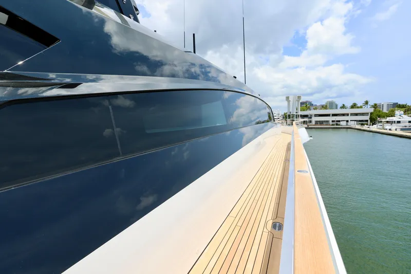  Yacht Photos Pics 2024 Rossinavi 49M Sport Yacht, sleek design, docked by waterfront, clear sky reflection.