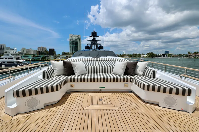  Yacht Photos Pics Luxurious deck seating on 2024 Rossinavi 49M Sport Yacht, with striped cushions and scenic waterfront view.
