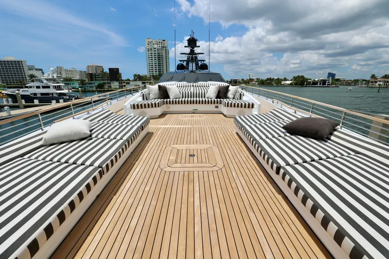  Yacht Photos Pics Luxurious 2024 Rossinavi 49M Sport Yacht deck with striped lounge seating.