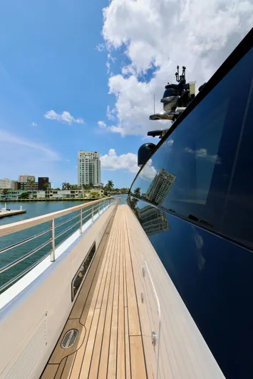  Yacht Photos Pics 2024 Rossinavi 49M Sport Yacht deck with city skyline and blue sky.