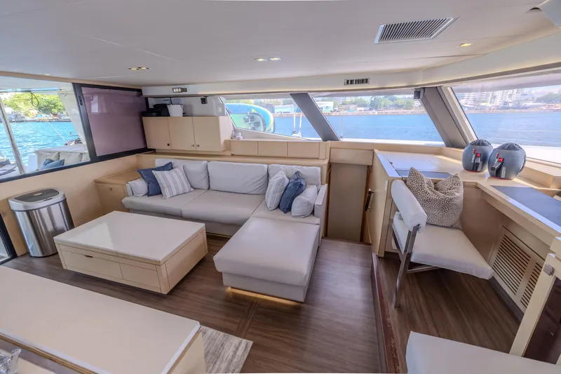  Yacht Photos Pics Luxurious interior of 2017 Fountaine Pajot Ipanema 58 yacht with modern seating and scenic views.