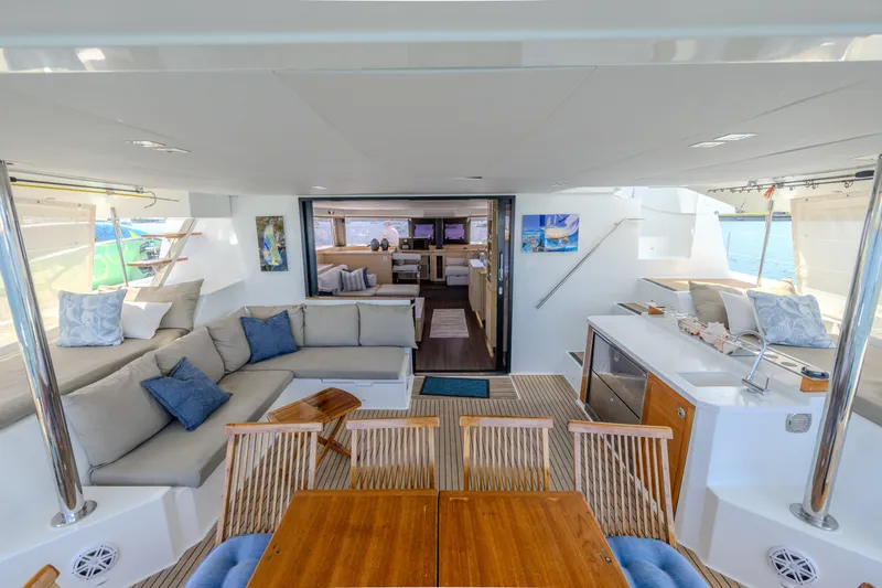  Yacht Photos Pics Luxurious interior of 2017 Fountaine Pajot Ipanema 58 catamaran with elegant seating and dining area.