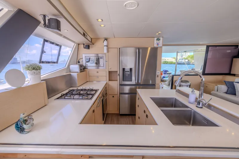  Yacht Photos Pics Luxurious 2017 Fountaine Pajot Ipanema 58 yacht kitchen with modern appliances and ocean view.