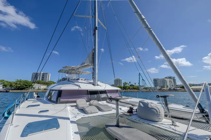  Yacht Photos Pics 2017 Fountaine Pajot Ipanema 58 catamaran docked in a sunny marina with cityscape views.