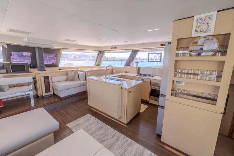  Yacht Photos Pics Luxurious interior of 2017 Fountaine Pajot Ipanema 58 catamaran with modern kitchen and seating area.