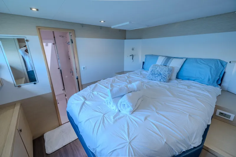  Yacht Photos Pics Luxurious bedroom interior on 2017 Fountaine Pajot Ipanema 58 yacht, featuring cozy bedding.