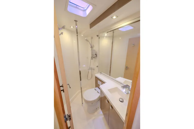  Yacht Photos Pics Luxurious bathroom in 2017 Fountaine Pajot Ipanema 58 yacht, featuring modern fixtures and skylight.