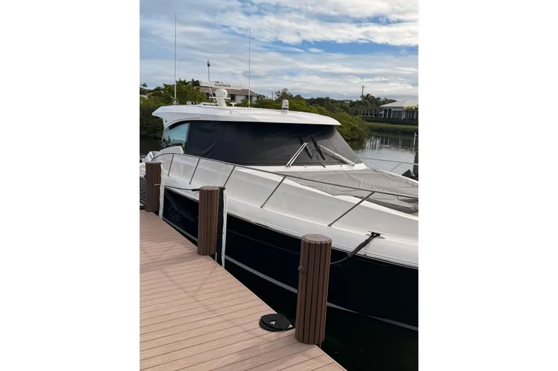  Yacht Photos Pics 2025 Tiara Yachts 48 LE docked, showcasing sleek design and modern features.