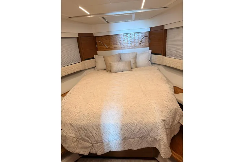  Yacht Photos Pics Luxurious bedroom interior of 2025 Tiara Yachts 48 LE with elegant bedding and modern design.