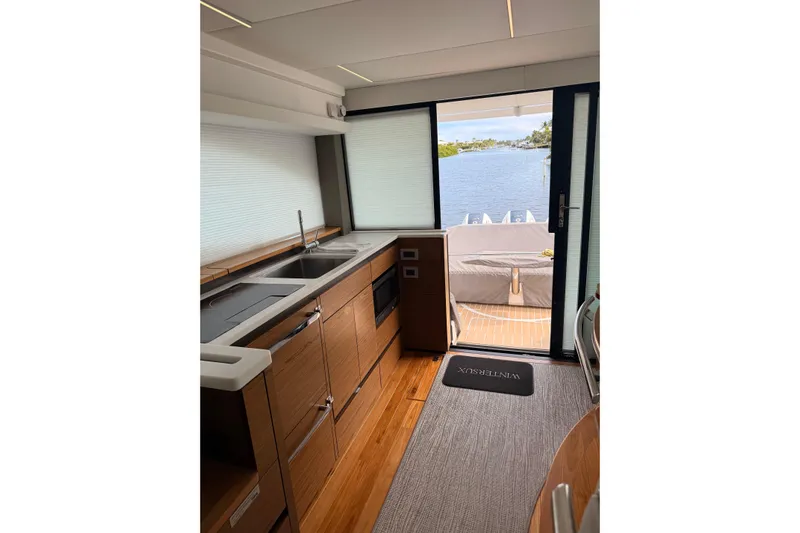  Yacht Photos Pics Interior of 2025 Tiara Yachts 48 LE, featuring modern kitchen and scenic water view.