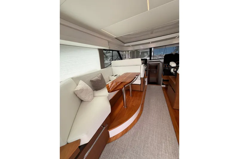  Yacht Photos Pics Luxurious interior of 2025 Tiara Yachts 48 LE with elegant seating and wooden accents.